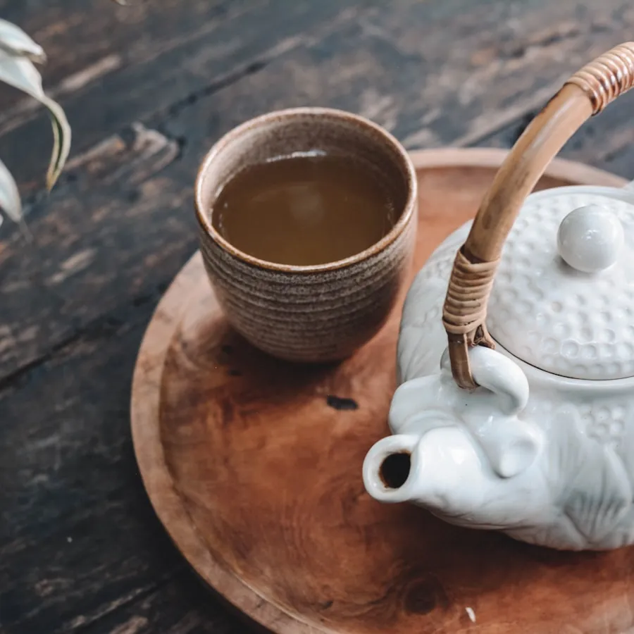 A rustic cup of tea sweetened with honey